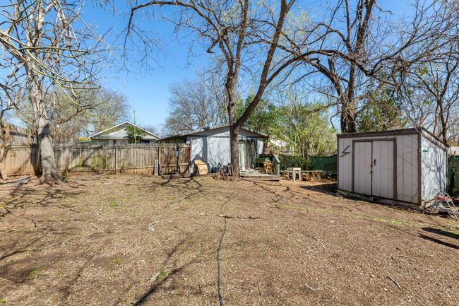View of yard with an outbuilding, a shed, and fence | Image 22