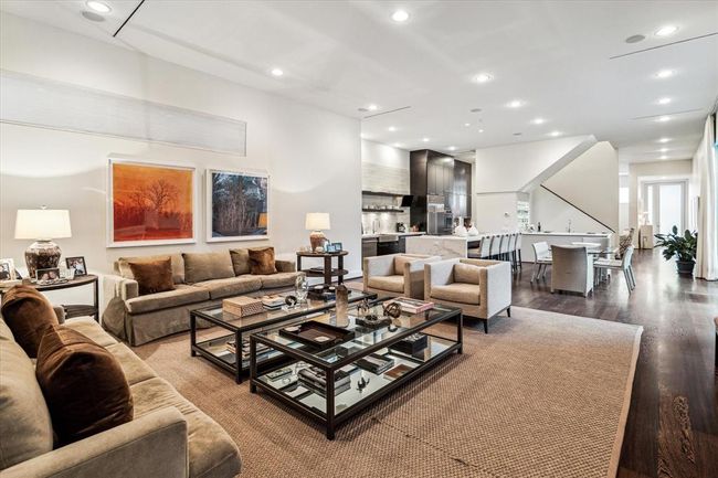 A larger view from the Family Room to the KItchen/Breakfast Room, Staircase and beyond to the Living/Dining areas and Front Entry Foyer. | Image 18