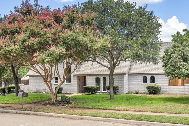 View of front facade with a front yard, brick siding, and roof with shingles | Image 21
