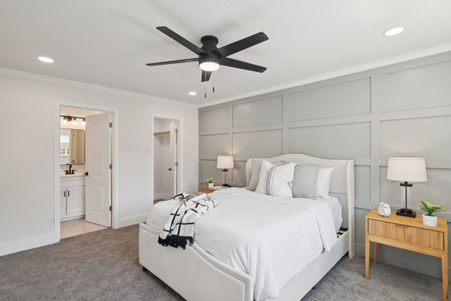 Carpeted bedroom featuring a decorative wall, ornamental molding, recessed lighting, ensuite bath, and a ceiling fan | Image 26