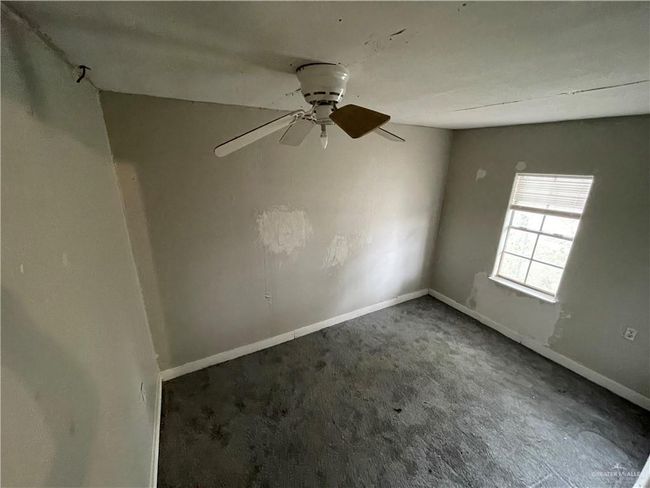 Spare room with carpet flooring, a ceiling fan, and baseboards | Image 16