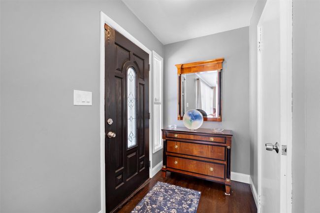 Entrance foyer with dark wood-style floors and baseboards | Image 5