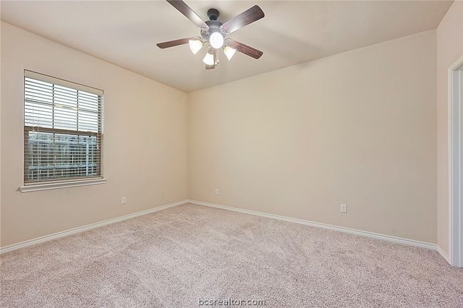 Carpeted empty room featuring baseboards and a ceiling fan | Image 9