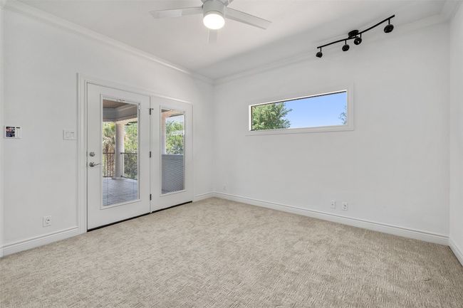 Carpeted spare room with ornamental molding, a ceiling fan, and baseboards | Image 29