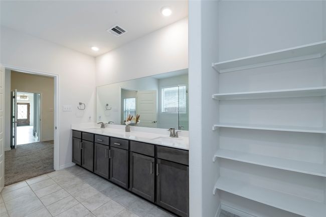 Full bathroom featuring light tile patterned flooring and double vanity | Image 18