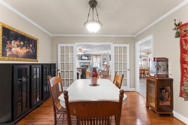 Another view of the dining room with doors. | Image 9