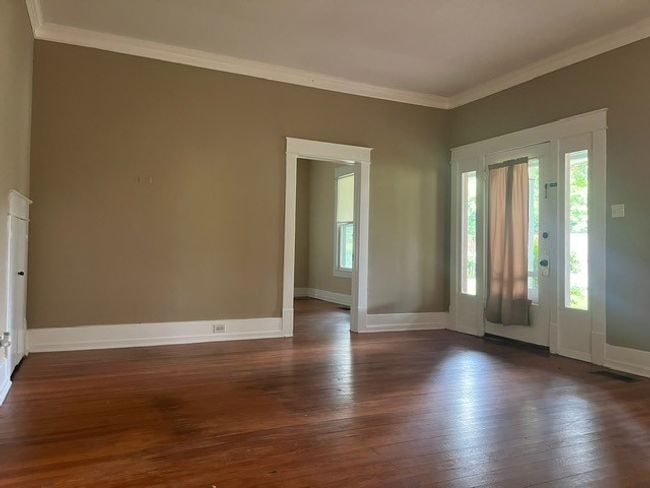 Foyer entrance with healthy amount of natural light, dark wood-type flooring, and crown molding | Image 5