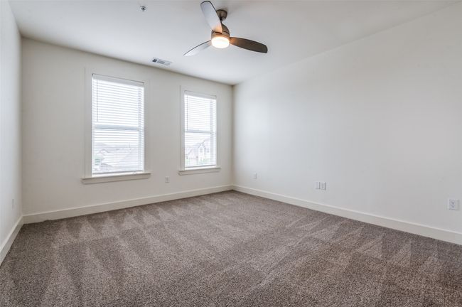 Unfurnished room featuring carpet floors, a ceiling fan, and fire sprinkler in ceiling | Image 18