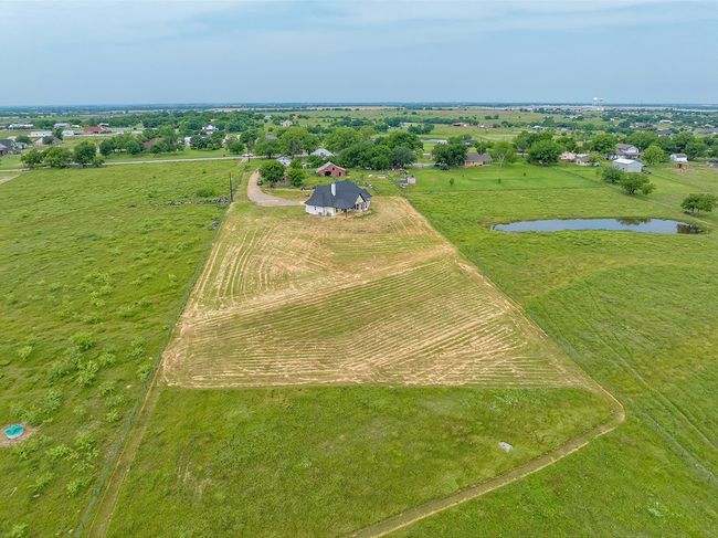 Aerial view of sparsely populated area featuring a nearby body of water | Image 33