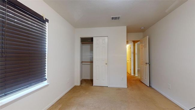 Cozy third guest bedroom with ample natural light and a convenient closet. | Image 31
