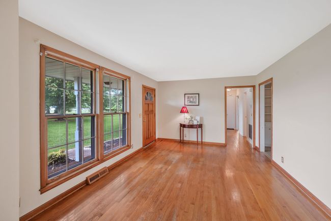 FORMAL LIVING ROOM WITH HARDWOOD FLOORS(RUN THRU OUT EXCEPT REC). DOUBLE FLOOR TO CEILING WINDOWS LOOKING OUT TO ROCKING CHAIR FRONT PORCH. | Image 14