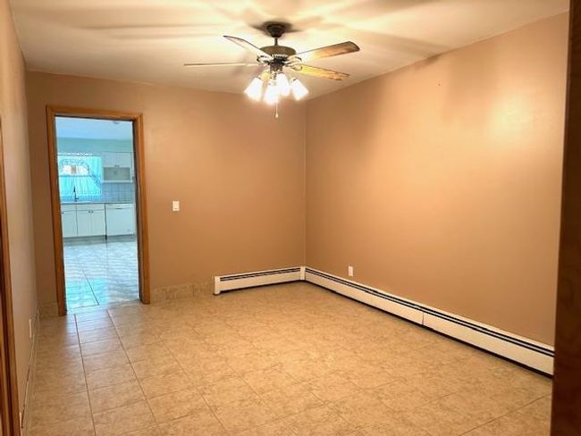 Spare room featuring a baseboard heating unit and ceiling fan | Image 20