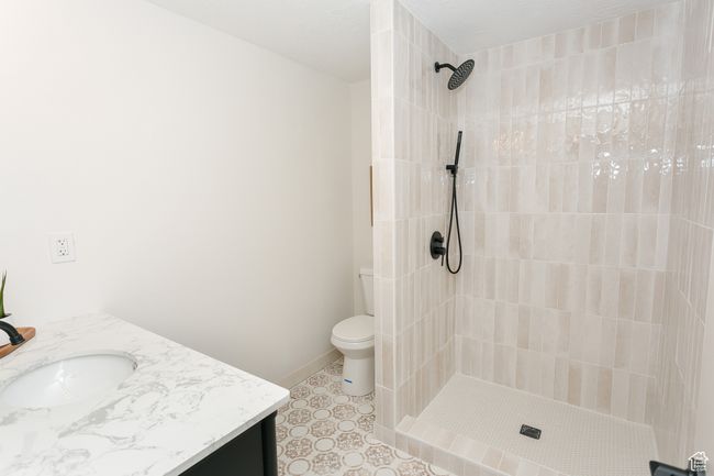 Bathroom with vanity, a tile shower, and toilet | Image 21