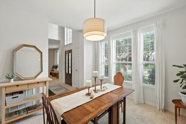 Dining space featuring light colored carpet and baseboards | Image 6