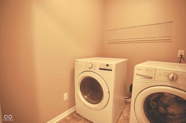 laundry room with washer and dryer, laundry area, and baseboards | Image 36