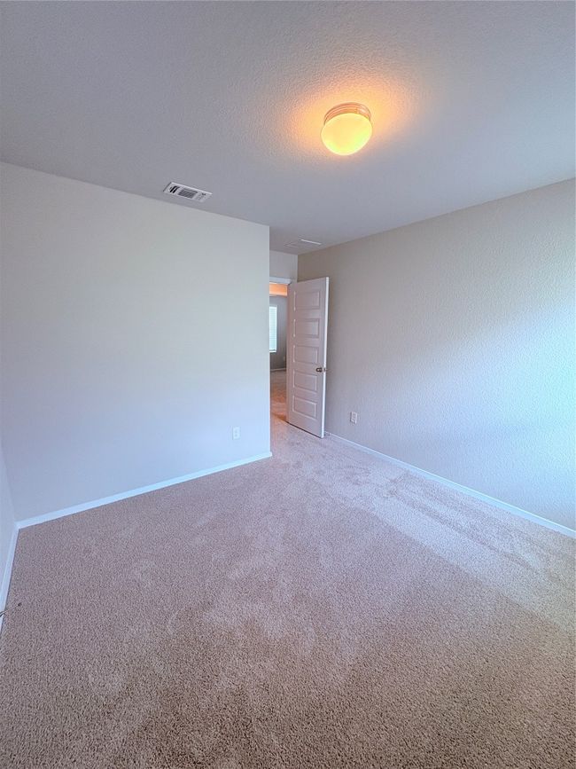 Spare room with baseboards, visible vents, carpet floors, and a textured ceiling | Image 20