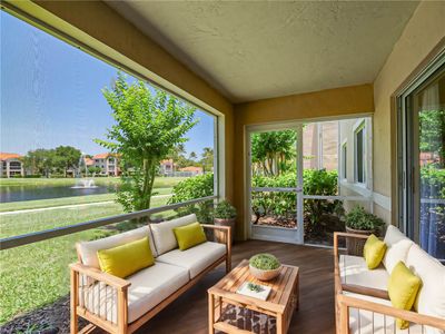 Relax and enjoy peaceful water view. Virtually staged screened porch. | Image 1