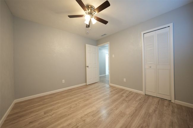 Unfurnished bedroom with light wood-style floors, a closet, ceiling fan, baseboards, and visible vents | Image 10