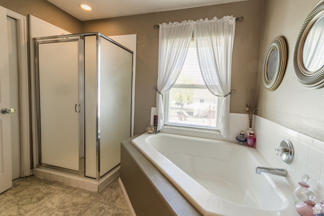 Bathroom with a shower stall and a garden tub | Image 16