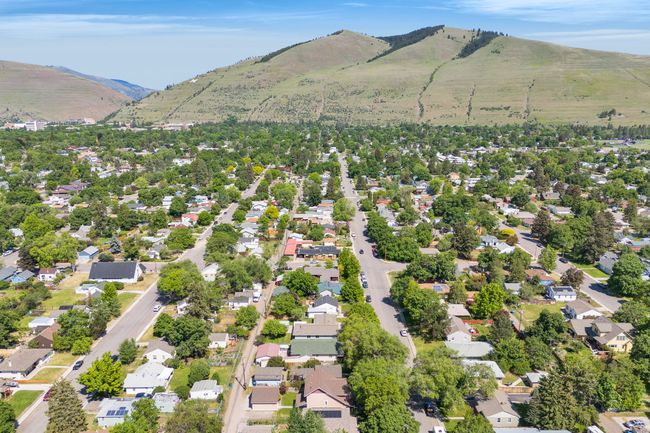 Aerial view of property's location featuring mountains and nearby suburban area | Image 59