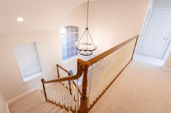Staircase with a chandelier, carpet, lofted ceiling, and recessed lighting | Image 7