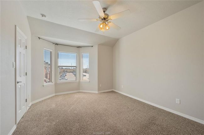 Empty room with a ceiling fan, baseboards, and light carpet | Image 21