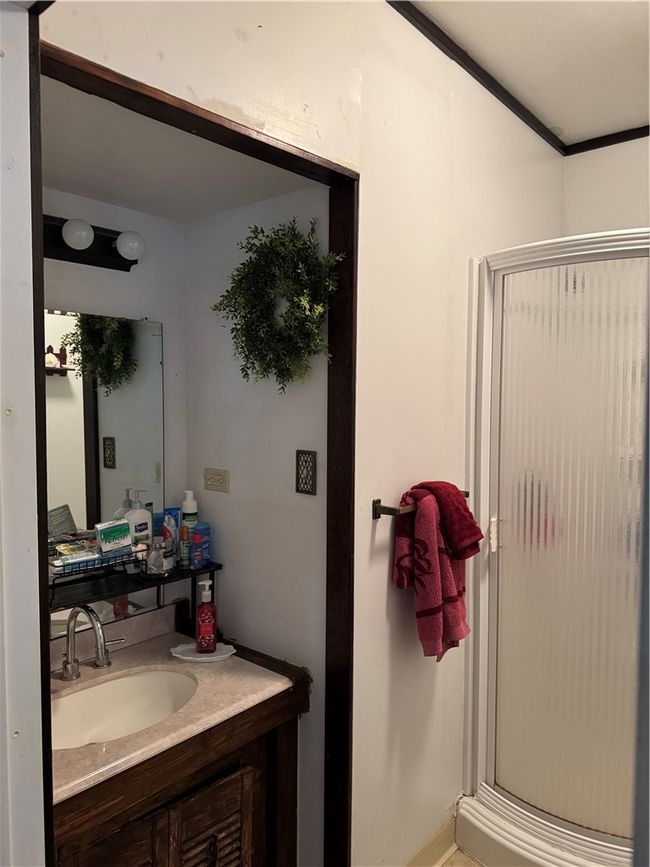 Bathroom featuring a shower stall and vanity | Image 14