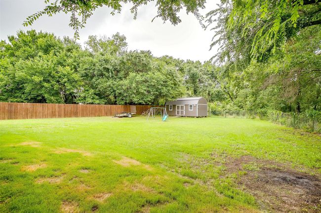 Fenced backyard with a shed | Image 34