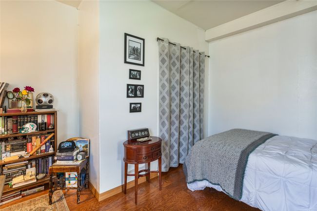 Bedroom featuring wood finished floors and baseboards | Image 14