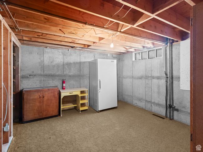 Unfinished below grade area with freestanding refrigerator | Image 26