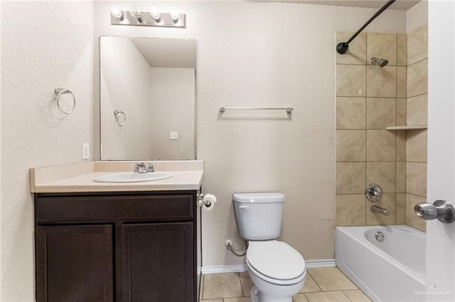 Bathroom featuring vanity, tile patterned floors, and shower / washtub combination | Image 25