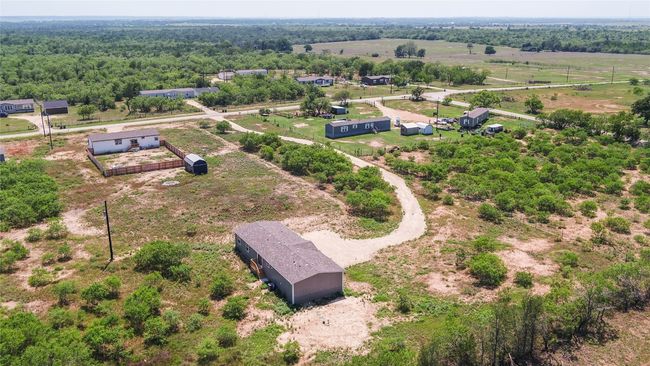 Aerial view of sparsely populated area with a heavily wooded area | Image 32
