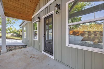 Notice the beautiful crafted wood ceiling on the porch. Includes modern recessed lighting. | Image 3