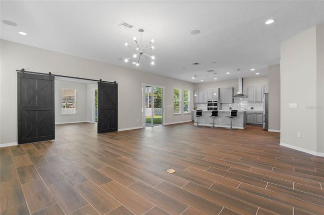 Great Room and entrance to Bonus Room with custom barndoors | Image 20