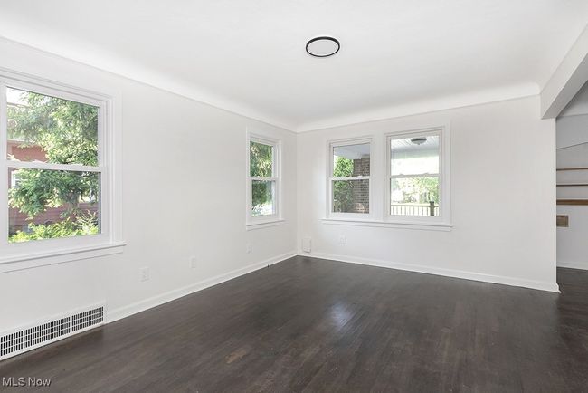 Empty room with radiator, dark hardwood / wood-style flooring, and a healthy amount of sunlight | Image 13
