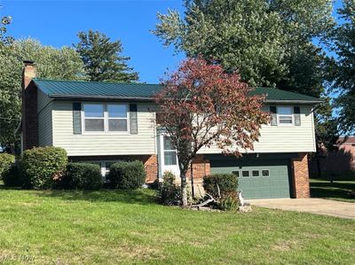 Split foyer home with a garage and a front yard | Image 1