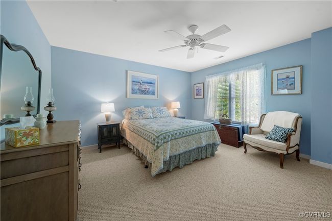 Bedroom with light carpet and a ceiling fan | Image 35