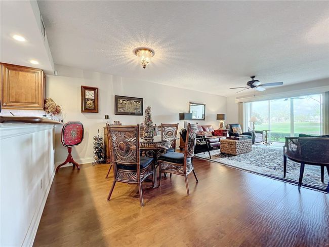 Kitchen bar opens to dining area and living room, plus year round back lanai | Image 15