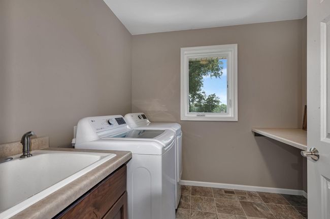 Laundry on the upper level thoughtfully located in the middle to create separation from the guest rooms and the primary | Image 26