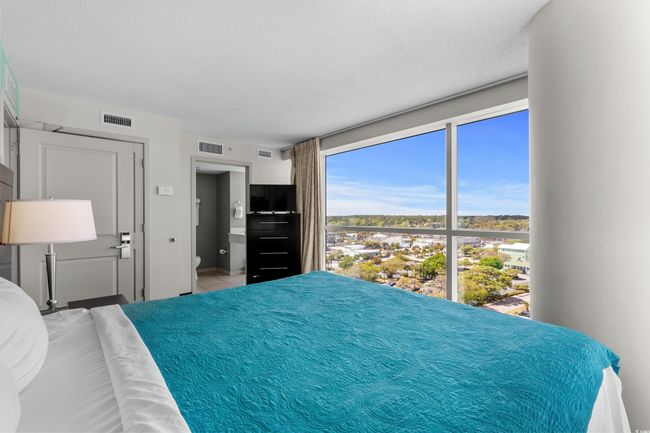 Bedroom with a textured ceiling and visible vents | Image 25