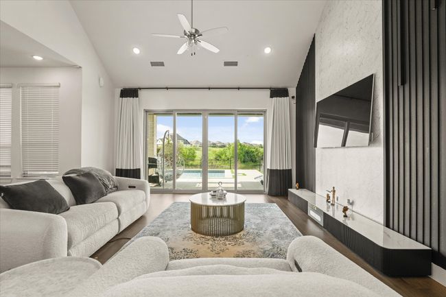 Living room featuring a ceiling fan, wood finished floors, recessed lighting, and high vaulted ceiling | Image 6