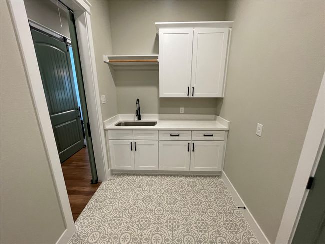 Washroom featuring a sink and baseboards | Image 34