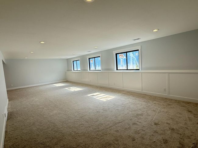 Daylight lower level-spacious family room with wall detail | Image 22