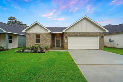 Notice the front landscaping with river rock. | Image 1