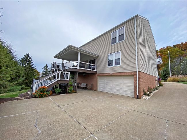 Rear view of the home. Concrete driveway with plenty of parking. | Image 31