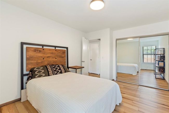 Bedroom with a closet and light wood-style floors | Image 16