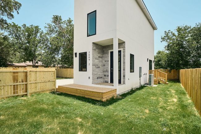 Back of property with stone siding, cooling unit, and stucco siding | Image 21
