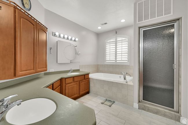 Full bath with a shower stall, a garden tub, vanity, and visible vents | Image 32
