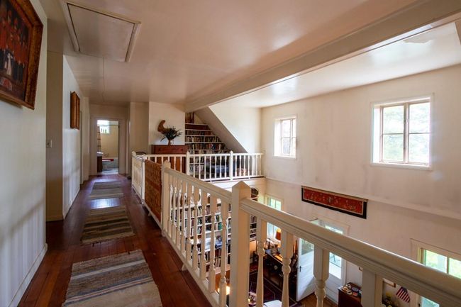 Hall featuring attic access, baseboards, an upstairs landing, and hardwood / wood-style floors | Image 15