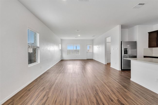 Unfurnished living room with dark wood-style flooring | Image 7